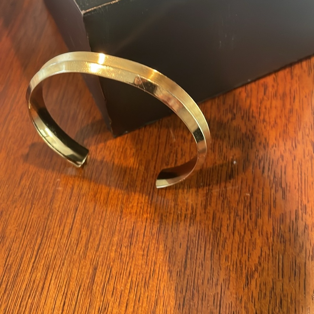 Maria Shireen Hair tie bracelet in stainless steel with a gold tone finish.
